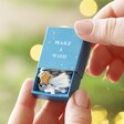 Model holding the Tiny Matchbox Ceramic Star Token in front of blurred Chritmas tree
