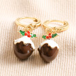 Christmas Pudding Huggie Hoop Earrings in Gold laid out on top of beige coloured fabric
