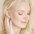 Model wearing Colourful Crystal Wreath Stud Earrings in Gold with hand behind ear