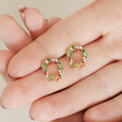 Model holding Colourful Crystal Wreath Stud Earrings in Gold between fingers in palm