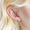 Close Up of Crystal and Enamel Flower Stud Earrings in Gold on model
