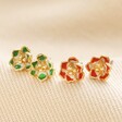 Green Enamel Flower Stud Earrings in Gold with other colour available in red on beige fabric