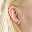 Close Up of Enamel Holly Stud Earrings in Gold on Model