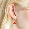 Close up of Enamel Toadstool and Pearl Huggie Hoop Earrings in Gold on blonde model