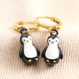 Penguin Charm Huggie Hoop Earrings in Gold on Beige Fabric