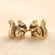 Squirrel Stud Earrings in Gold on Beige Fabric 