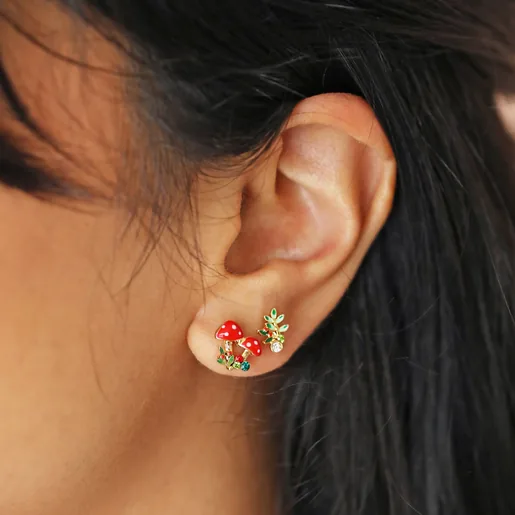 Close Up of Model Wearing Set of Four Enamel Woodland Stud Earrings in Gold