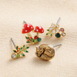 Set of Four Enamel Woodland Stud Earrings in Gold on a White Surface