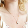 Close Up of Model Wearing Christmas Pudding Necklace in Gold 