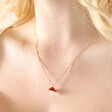 Close up of Pearl and Enamel Toadstool Pendant Necklace in Gold on blonde model