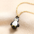 Penguin Pendant Necklace in Gold on Beige Fabric 
