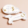 Cat Quote Trinket Dish with dog shaped trinket dish on top of beige coloured backdrop with jewellery on top