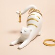 Ceramic Stretching Cat Ring Holder Holding Rings on Pink Surface 