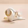 Back of Ceramic Stretching Cat Ring Holder on Pink Surface