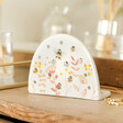 Close up of Dusky Pink Floral Bee Ceramic Earring Holder on wooden table in lifestyle shot