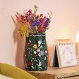 Forest Green Flower Vase on wooden counter with flip chart in background