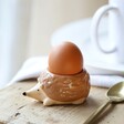 Hedgehog Egg Cup on wooden surface with egg in cup