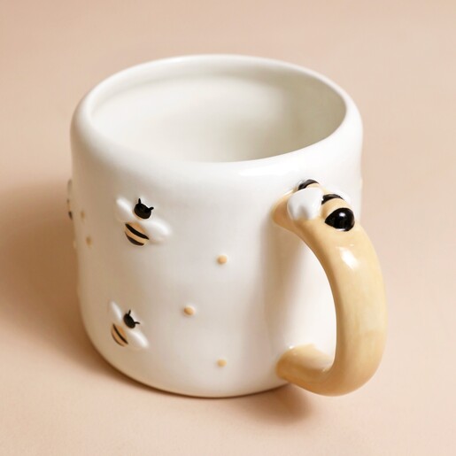 Irregular Ceramic Bee Mug in front of beige coloured backdrop