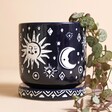 Midnight Blue Sun and Moon Planter and Tray with plant inside in front of neutral coloured backdrop