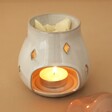 Pink Ceramic Toadstool Wax Burner with lit candle in the base and wax melt in the top