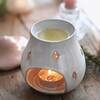 Pink Ceramic Toadstool Wax Burner in lifestyle shot with lit tealight in base and toadstool top behind 