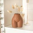 Small Porcelain Body Vase in lifestyle shot with bunny tails inside