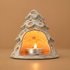 White Ceramic Christmas Tree Tealight Holder with lit tealight inside against neutral backdrop