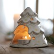 Close up of White Ceramic Christmas Tree Tealight Holder showing lit tealight inside