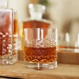 Whisky glass from Personalised Whisky Glass and Decanter Set in lifestyle shot in front of mirror