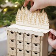 Model building forest scene from Personalised Wooden Forest Cutout Advent Calendar on top of calendar