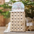 Personalised Wooden Market Cutout Advent Calendar in front of Christmas tree