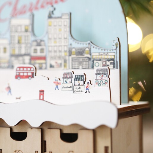 Close up of details on Personalised Wooden Market Cutout Advent Calendar topper