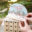 Model placing topper on top of Personalised Wooden Market Cutout Advent Calendar