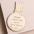 Personalised Wooden Medal Token on pink surface