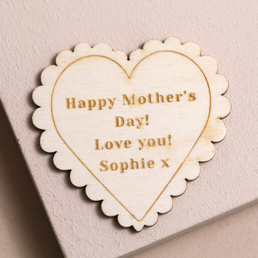 Personalised Wooden Scalloped Heart Token on pink surface