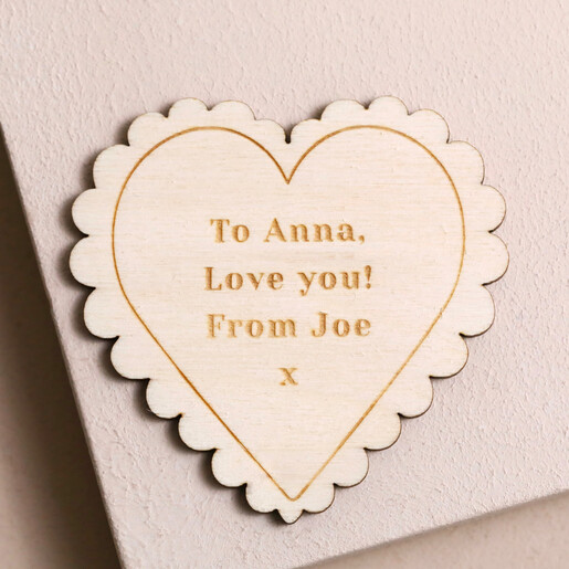 Engraved Personalised Wooden Scalloped Heart Token on surface