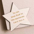 Engraved Personalised Wooden Star Token on pink wooden surface