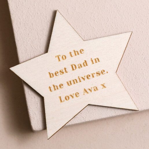 Engraved Personalised Wooden Star Token on pink wooden surface