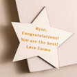 Personalised Wooden Star Token on pink surface