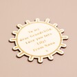 Personalised Wooden Sun Token on pink background