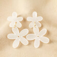 Pearlescent Acrylic Flower Drop Earrings against neutral coloured fabric