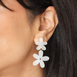 Close up of Pearlescent Acrylic Flower Drop Earrings on dark-haired model