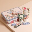 Cath Kidston The Artist's Kingdom Nail Care Kit With products arranged next to tin on beige background