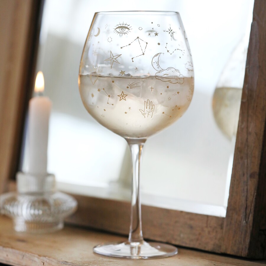 Gold Celestial Balloon Gin Glass against wooden counter