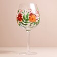Hand-Painted Wildflower Balloon Gin Glass with beige coloured backdrop