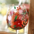 Close up of Hand-Painted Wildflower Balloon Gin Glass in front of mirror