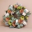 Wooden Pink and Green Blooms Wreath on Beige Surface