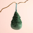 Jellycat Plush Festive Folly Christmas Tree Decoration hanging from tree branch against neutral background