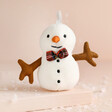 Jellycat Plush Festive Folly Snowman Decoration on neutral background with snow 