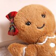Jellycat Jolly Gingerbread Ruby Soft Toy on top of beige coloured backdrop